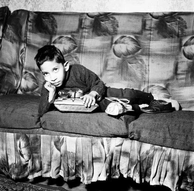 Boy on a sofa with a tank