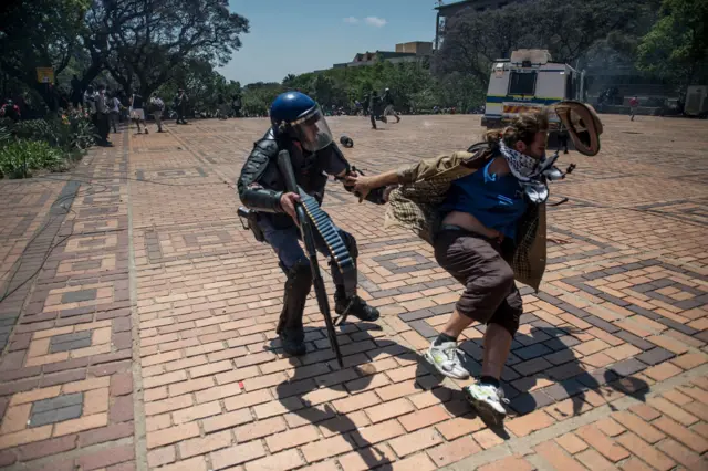 A student is arrested by a riot police officer at Wits University 11 October