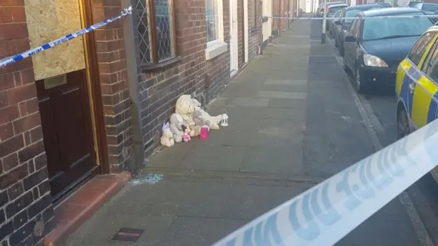 Tributes left outside the home on Packett Street