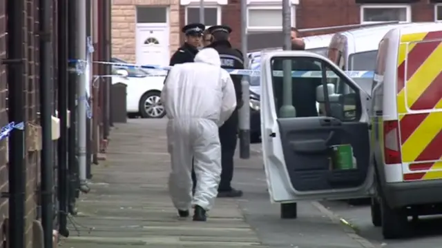 A forensic officer on the scene on Packett Street, Stoke-on-Trent