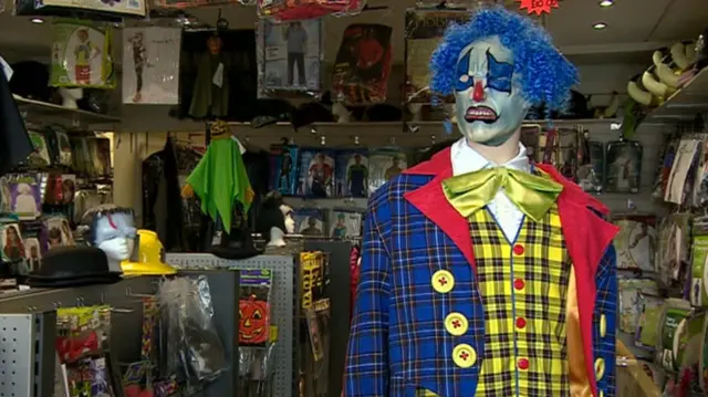 A clown mannequin in a store