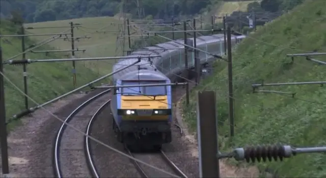 Abellio Greater Anglia train on tracks, with overhead cables