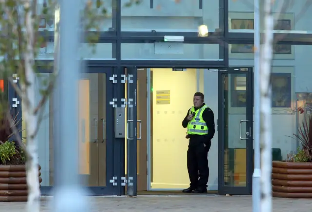 Officer at school door