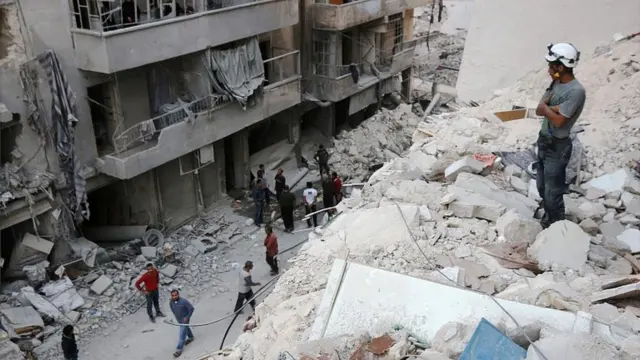 Member of White Helmet volunteer force in the ruins of a building in Aleppo