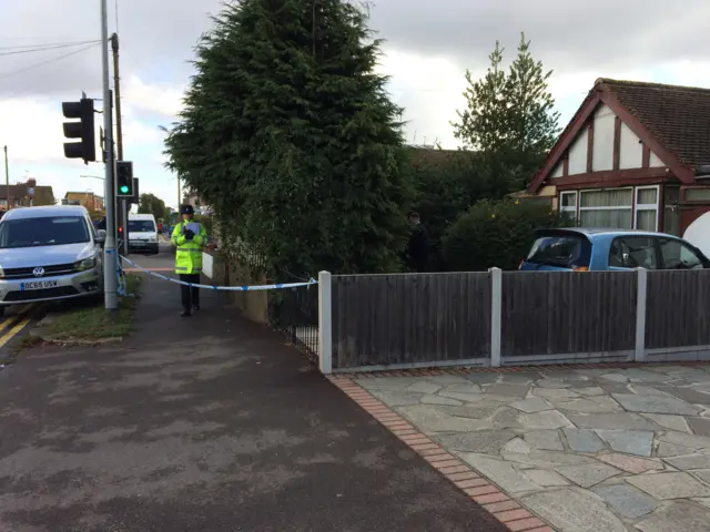 Police officer outside bungalow