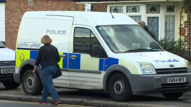 Police van outside bungalow