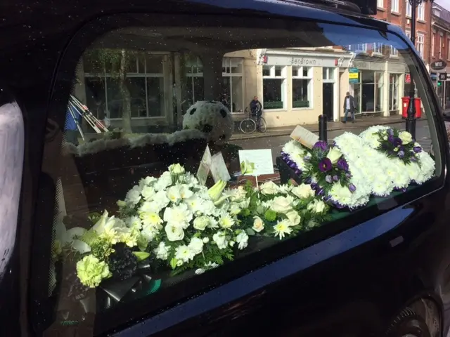 Floral tribute from family to Gordon Guthrie.