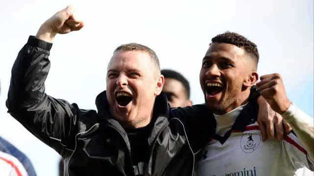 Rob Smith celebrates with player