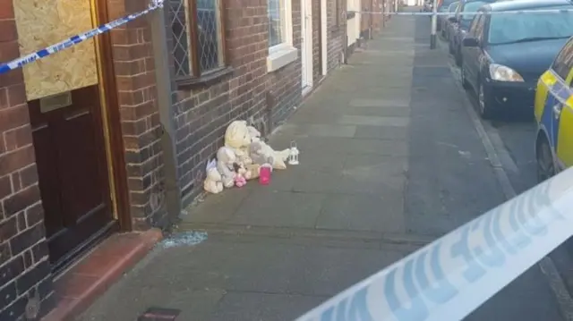 Tributes placed outside house on Packett Street