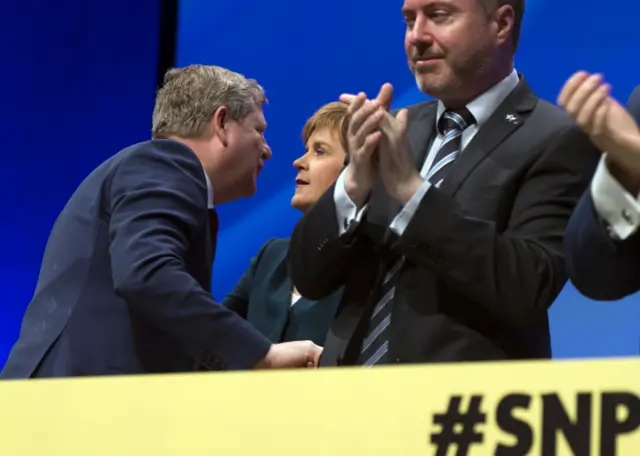 Newly elected party deputy Angus Robertson leans in towards Nicola Sturgeon