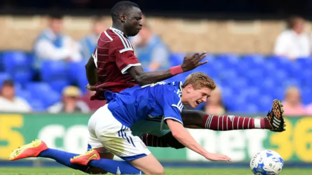 Teddy Bishop falls to the ground following a challenge