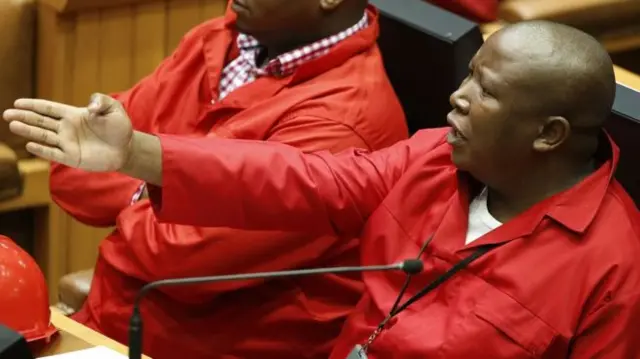 Julius Malema in red overalls in parliament