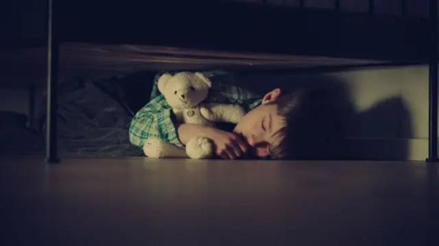 Library picture of child under a bed