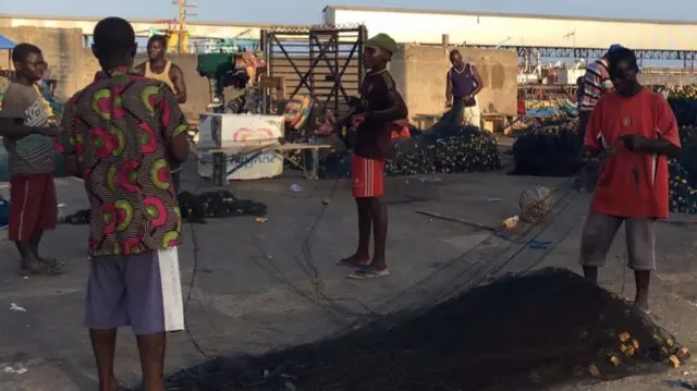 Togolese fishermen tending nets