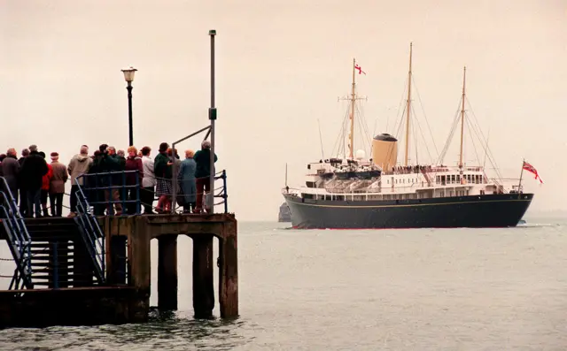 crowds watch the royal yacht