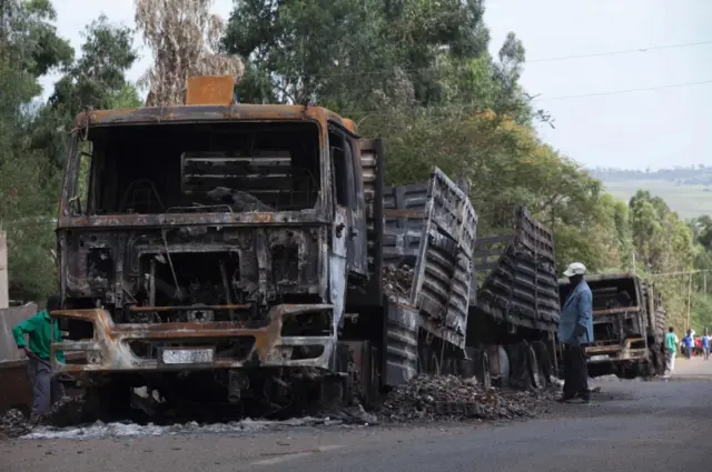 A man stands next to a destroyed cargo truck in Sebeta on October 13, 2016.