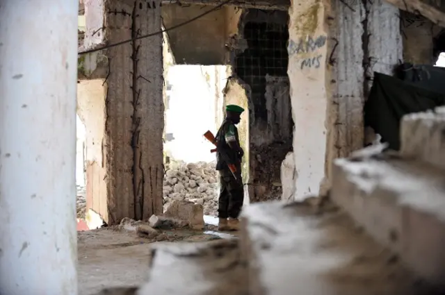 An African Union (AU) soldier from Uganda walks through what used to be Hotel Uruba, on July 23, 2012 in the Somali capital Mogadishu.
