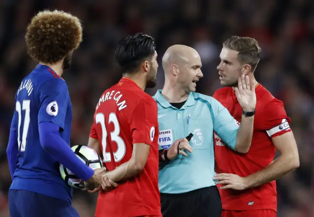 Jordan Henderson remonstrates with Anthony Taylor