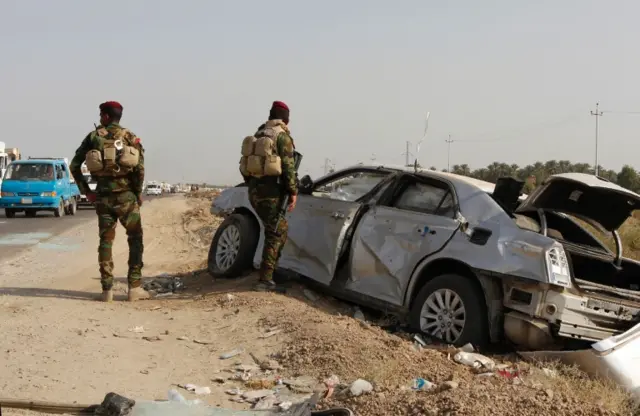 Scene of a car bomb attack in Yusufiya, south of Baghdad