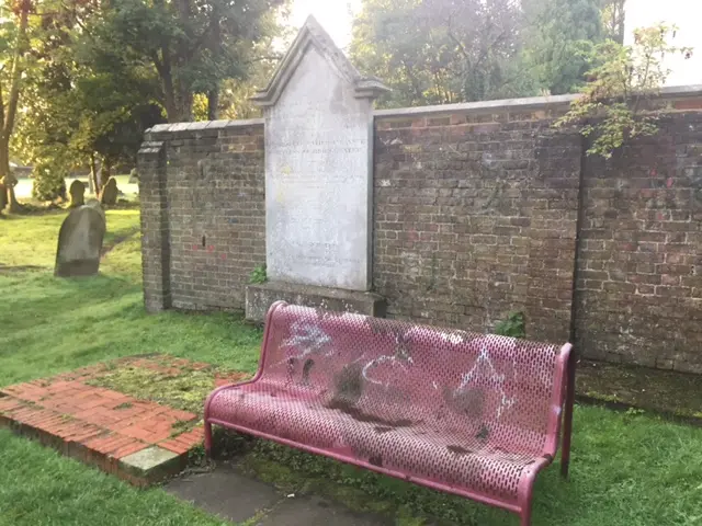 Bench strayed with graffiti at Rectory Lane Cemetary in Berkhamsted