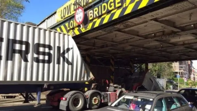 Lorry stuck under bridge