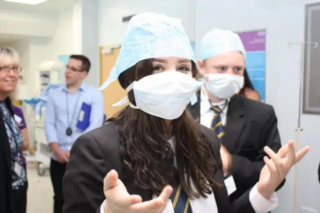 School pupils in scrubs at a hospital