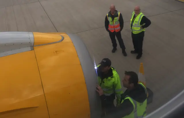 Engineers inspect the engine.