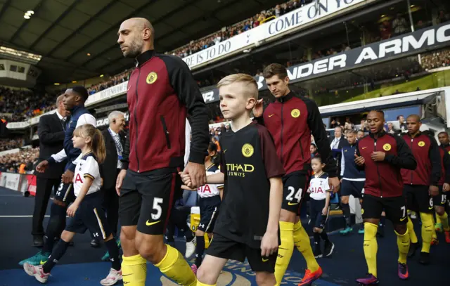 Manchester City players walk on to the pitch