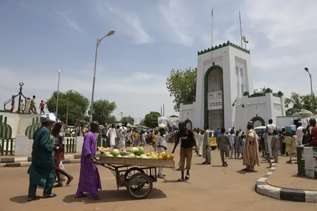 A vendor hawks water melon in a cart past the grounds of the palace of the Sultan of Sokoto Muhammadu Sa'ad Abubakar and President-General of the Nigerian National Supreme Council for Islamic Affairs (NSCIA) in Sokoto, northwest Nigeria on August 23, 2016.