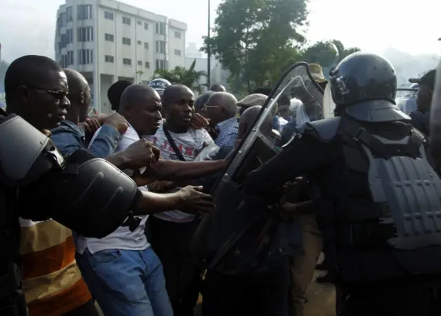 Riot police arrest demonstrators during a protest against a referendum on the adoption of a new constitution, Abidjan, Ivory Coast, 20 October 2016.