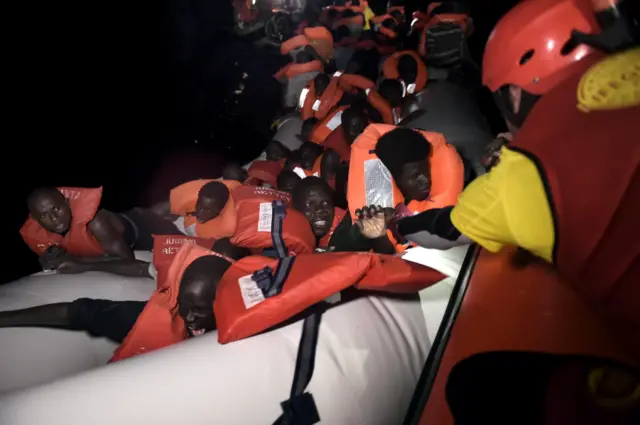 Migrants scramble to escape their sinking rubber dinghy