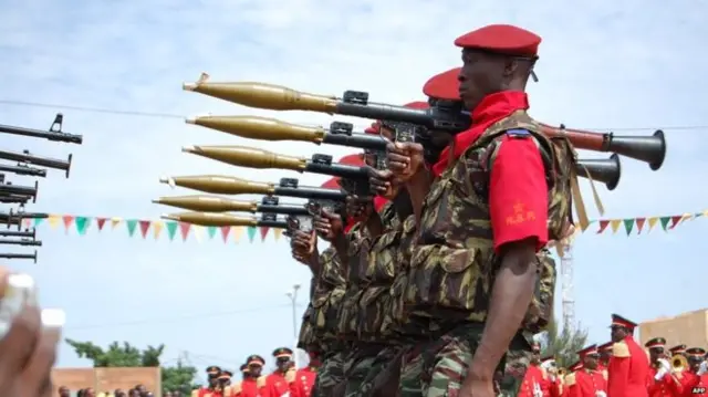 Presidential guards stand on ceremony, armed with rocket propelled grenades