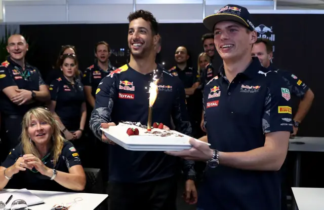 Daniel Ricciardoand Max Verstappen present Lindsey Vonn with a birthday cake