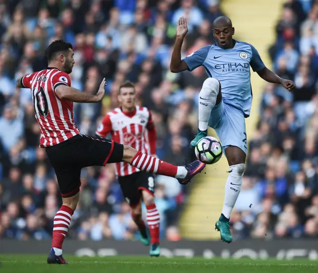 Charlie Austin vies with Fernandinho