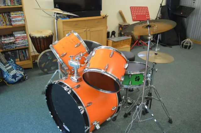 The orange drum kit with green snare