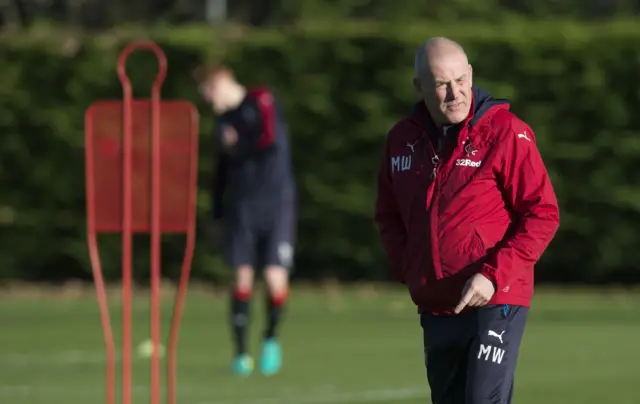 Rangers manager Mark Warburton grimaces in the sunlight at training