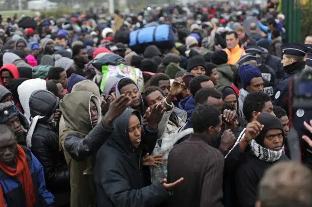 Migrants queue in Calais