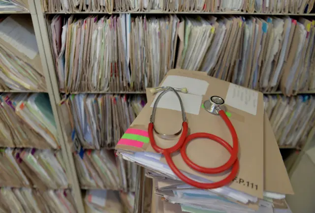 Files and a stethoscope in a GP's surgery