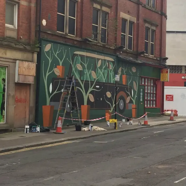 Wall cordoned off with painting underway