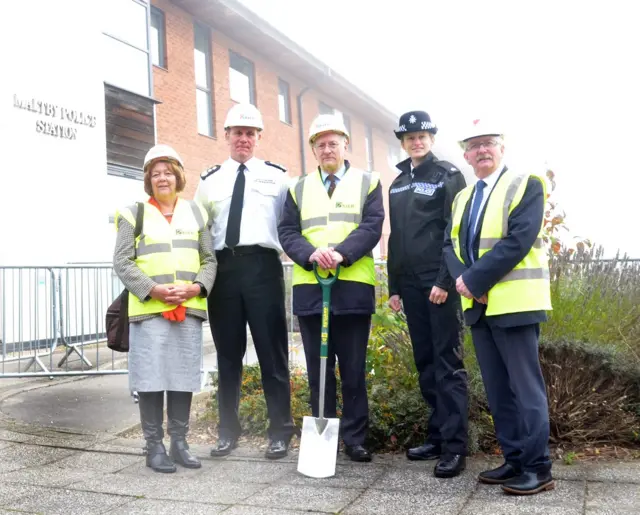 PCC Billings holding spade with others at the site