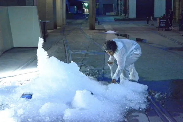 Woman shoveling ice