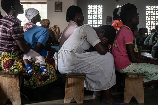 Women pray during Sunday service at Mofolo Woyera church