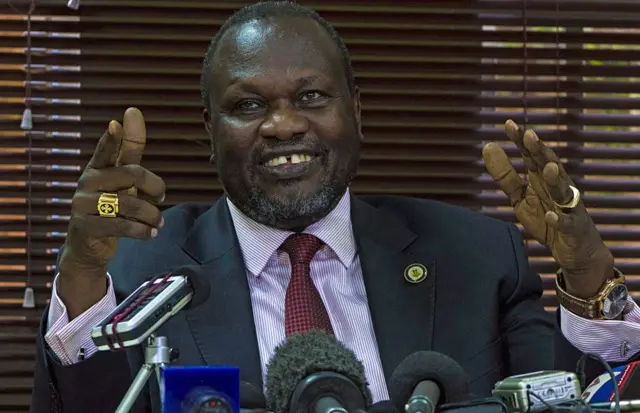 South Sudan's rebel leader Riek Machar gestures as he holds a press conference in Kampala on January 26, 2016