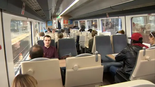 Interior of rail carriage, with passengers