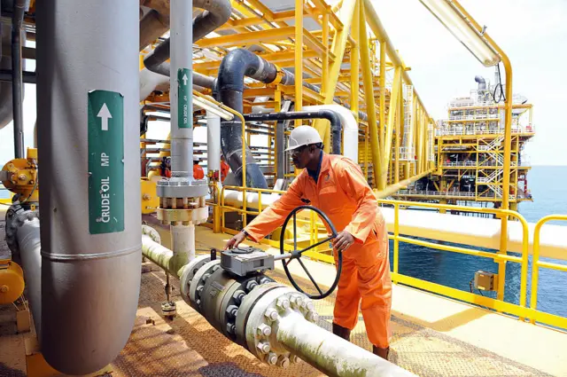 A worker inspect facilities on an upstream oil drilling platform