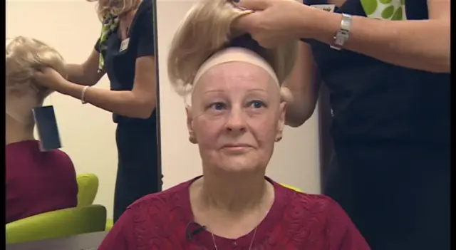 Woman having wig fitted