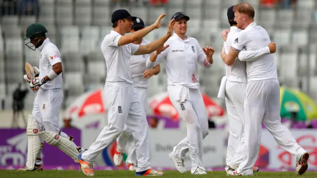 England's players celebrate the wicket of Sabbir