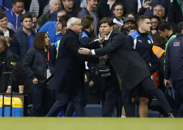 Managers shake hands at full-time