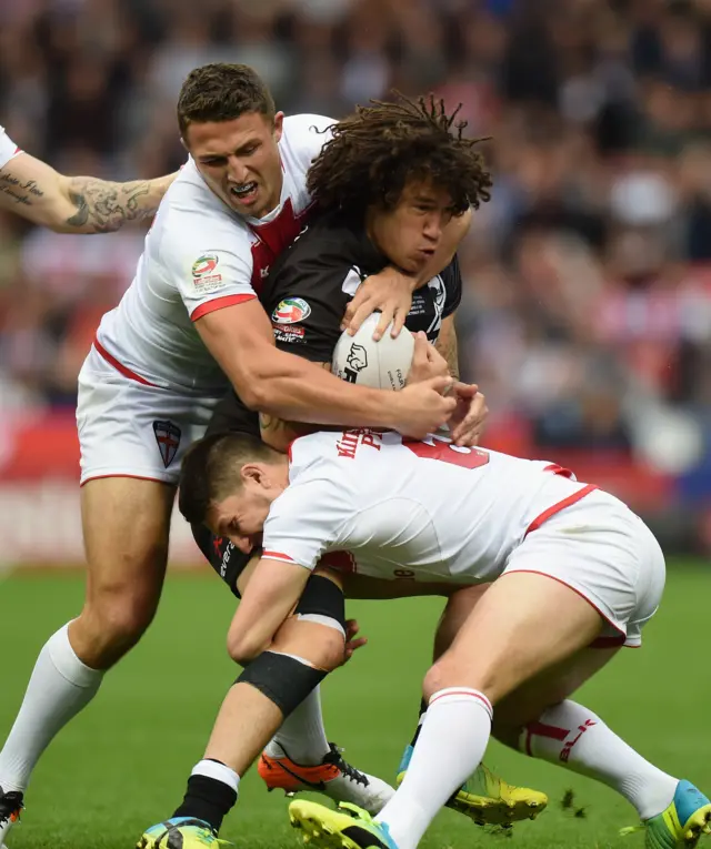 Sam Burgess and Gareth Widdop of England tackle Kevin Proctor of New Zealand Kiwis