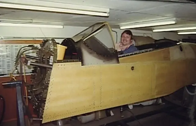 Maurice Hammond sitting in the airframe of the Mustang, while it was undergoing restoration work